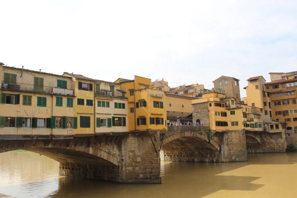 Ponte Vecchio bridge with muddy waters underneath