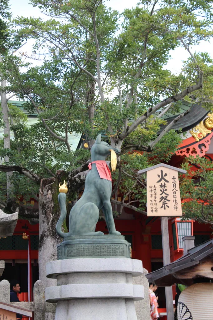 A statue of a fox at Fushimi Inari Shrine, a symbol of the shrine and associated with the Inari deity.