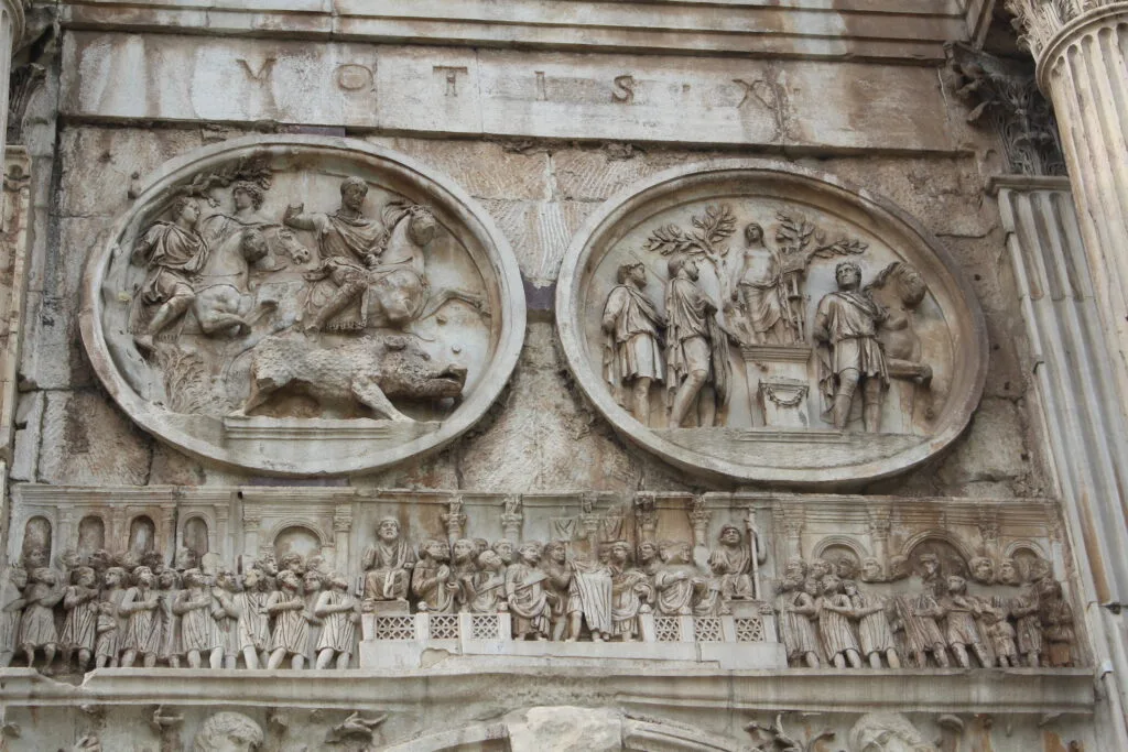 Detailed carvings on the Arch of Titus, depicting historical Roman scenes.