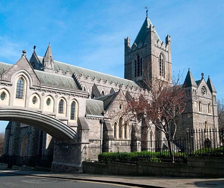 Exterior view of Christ Church Cathedral in Dublin, showcasing its Gothic architecture, tall spires, and intricate stone details.