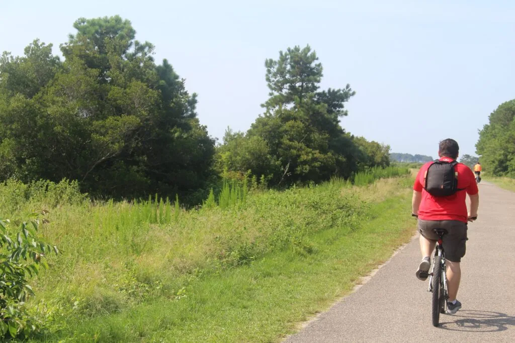 Spencer riding his bike through the Wildlife Loop Trail! Spotting nature is one of the best things to do in Chincoteague. 