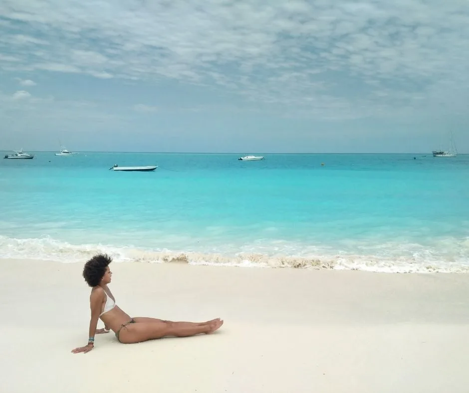 Woman on a white sand beach in Zanzibar