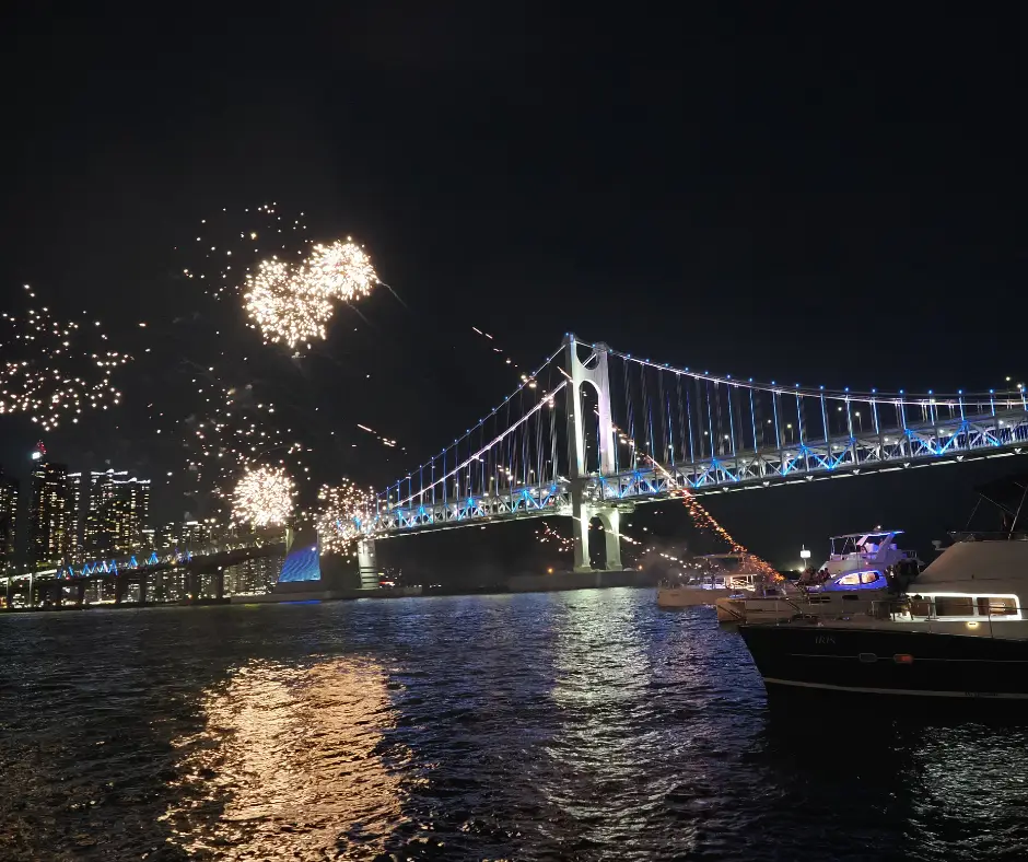 Boats setting off fireworks in front of Gwangan Bridge, Busan